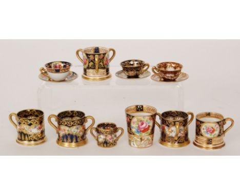 A collection of Crown Staffordshire miniature porcelain to include two three handled tygs, a loving cup, a mug, cups and sauc