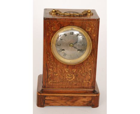 A late 19th Century marquetry inlaid rosewood mantle clock with circular silvered dial and eight day striking movement, the c