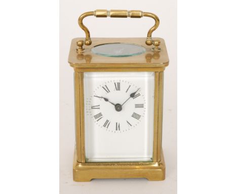 A 20th Century French brass carriage clock with white enamelled dial on bracket plinth, height 10.5cm