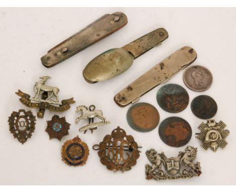 A three piece folding campaign knife, fork and spoon set together with a small quantity of military badges etc.