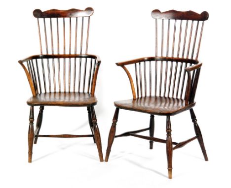 A pair of late 19th Century Windsor comb back elm seat and beech elbow chairs on turned splayed legs united by swept stretche