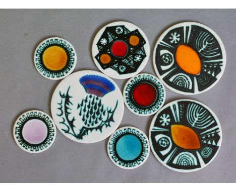 Ann Wynn Reeves and Kenneth Clark - Eight circular tiles or coasters each decorated with copper resist and gloss glaze highli