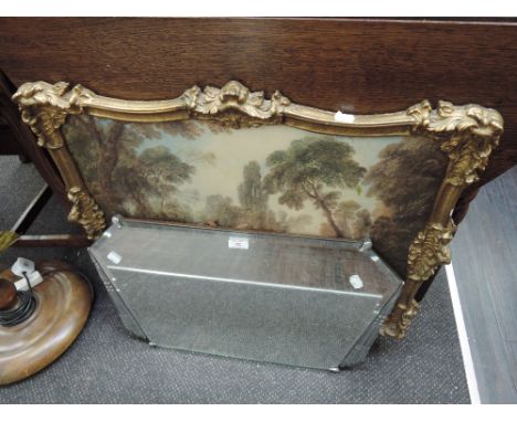 An art deco style wall mirror and a gilt effect fireguard 