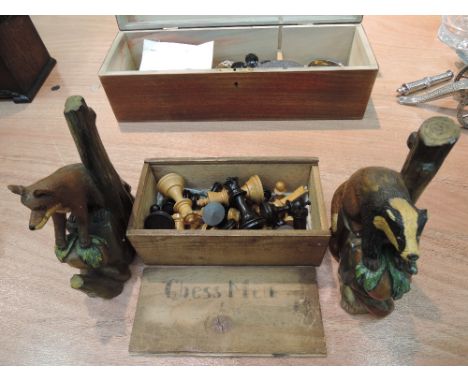 A selection of vintage wooden chess pieces and a pair of treen bookends modelled as Badger and Fox