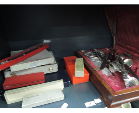 A shelf of platedware including canteen of cutlery etc 