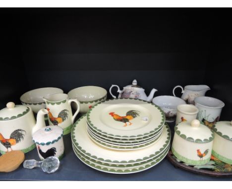 A shelf of decorative ceramics including Fairmont & Main dinnerwares in the cockerel pattern