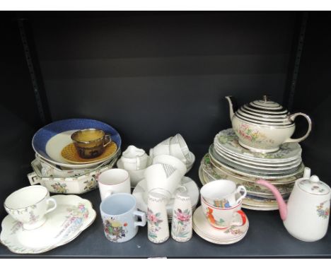 A shelf of decorative ceramics including part tea service, plates etc