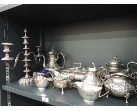 A shelf of platedware including candelabra, teapot and coffee pot etc