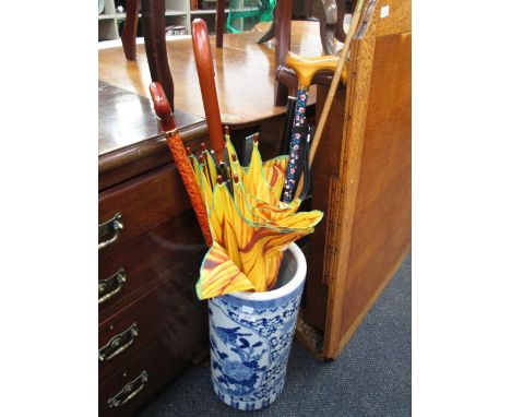 A 20th century Chinese blue & white stick stand containing a selection of sticks, umbrellas and a yard stick