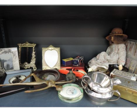 A shelf of miscellaneous including cigarette cards, trinket boxes etc 