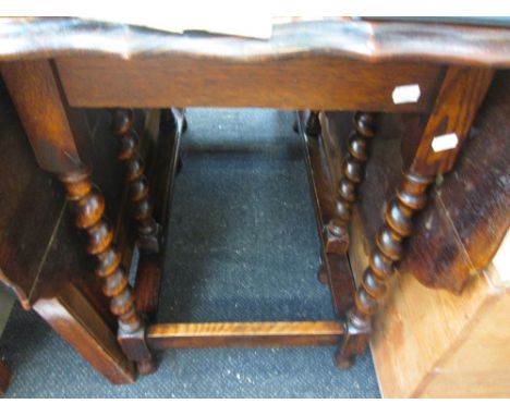 An early/mid 20th century oak scallop gate leg dining table