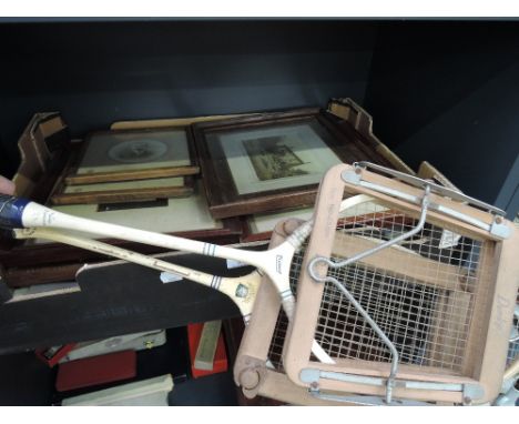 A selection of framed black and white photographs and two vintage badminton rackets 
