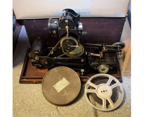 A vintage Pathescope PB-EX reel projector, cased with reels