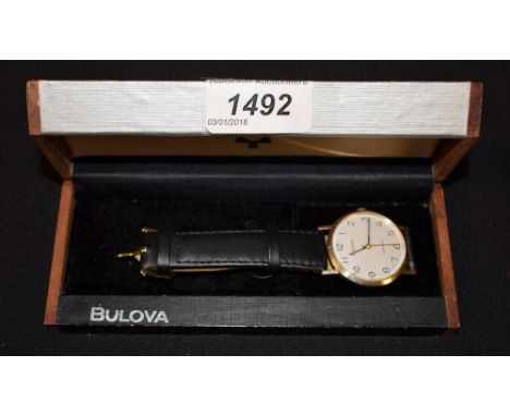 Bulova - a vintage 1970s gentleman's Longchamp 9ct gold wristwatch, silvered dial, raised black Arabic numerals, minute track