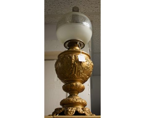 A large Victorian oil lamp, playful cherubs and satyr mask feet