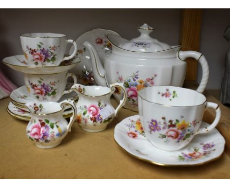 A Royal Crown Derby Posie pattern tea pot, two teacups, a breakfast cup, three saucers, four tea plates, two graduated milk j