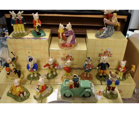 A Royal Doulton Rupert the Bear model, Banging on his Drum;  others Rupert Bill and his Mysterious Car; Poggy Lands with a Bu