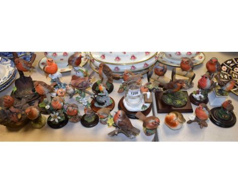 A Country Artists resin model, Robin on Trowel, CA 484; other similar assorted ceramic and resin robin models, Royal Doulton,