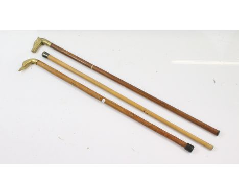 Collection of three walking sticks to include silver handled walking cane hallmarked for London 1920, brass handled walking s
