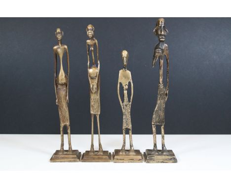 Four brass tribal art figures of elongated form on square bases, tallest measures 29cm approx