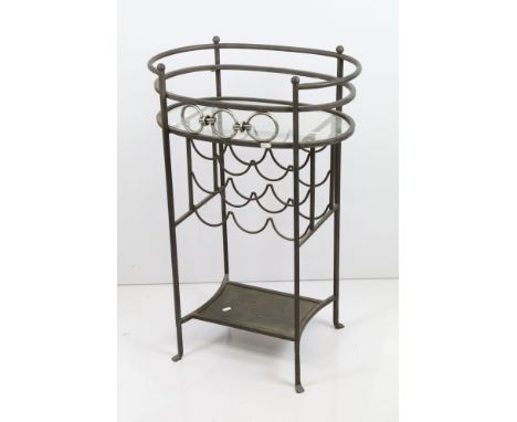 Cast metal oval four legged drinks side table with glass shelf and wine rack holder for nine bottles and shelf to bottom, H 8