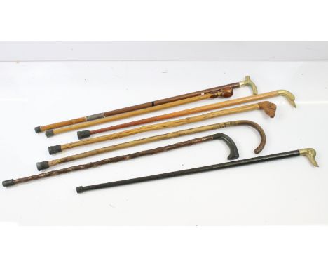 Collection of seven walking sticks to include 3 x brass handled walking sticks (2 x in the form of a duck and 1 x ebonised ex