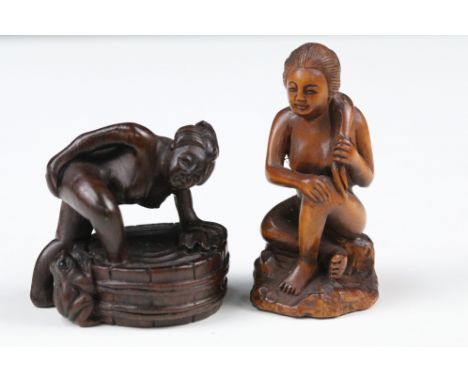 Two Japanese wooden carved netsuke of nude females, both with character marks to base.