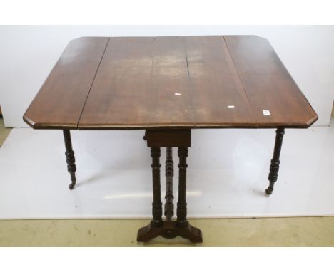 Late 19th/ early 20th century mahogany folding table top with gate leg base, turned legs and stretcher, raised on casters, W 