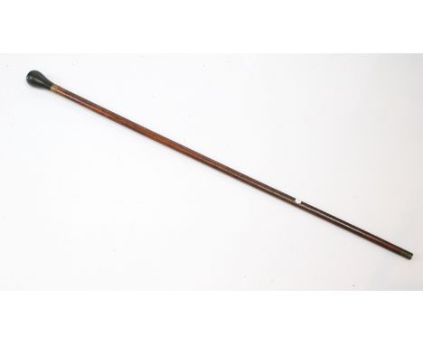 Ebonised handled walking cane with brass details and end 