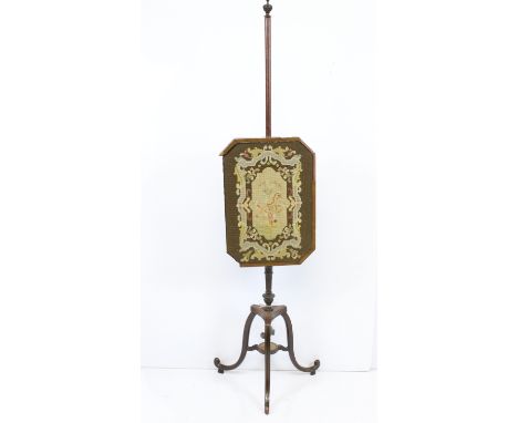 A Victorian mahogany adjustable fireside pole screen with cabriole legs and a needlework tapestry depicting a bird with ornat