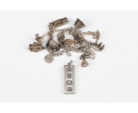 A sterling silver charm bracelet with a good selection of charms together with a hallmarked silver ingot pendant. 
