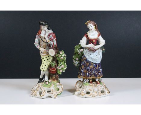 Pair of Royal Crown Derby 'Musician' figurines, man with pipe and girl with triangle set atop ornate scrolled bases, H 21cm