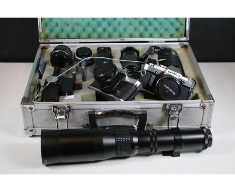 Olympus OM30 camera together with a Fujica ST605, lenses and accessories, including Miranda and Bell and Howell examples, cas