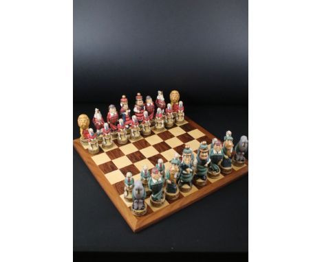 A Alice in Wonderland resin chess set together with chessboard 
