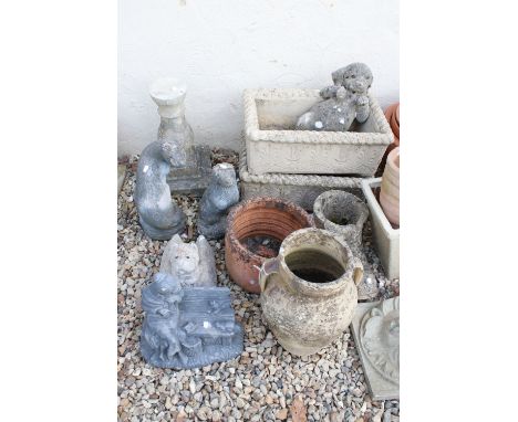 Pottery urn and a pair of rectangular planters together with a selection of stone ornaments to include otters, dog, boot and 