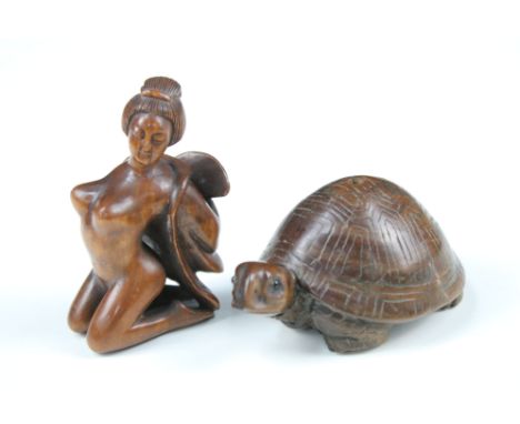 Two Japanese wooden carved netsuke of a nude female and a Tortoise, both with character marks to base.