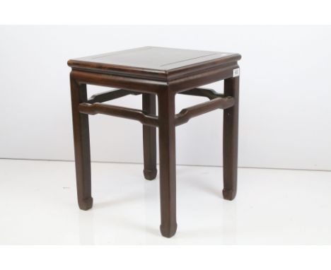 Late 19th century blackwood stool with square top above four block supports, each with carved foot united by stretcher, H 50.