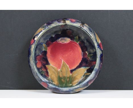 William Moorcroft pomegranate pattern shallow bowl / ashtray on dark blue ground with berries and pomegranate decoration, sig