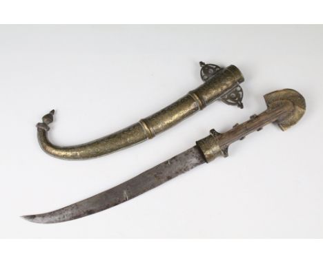 An early 20th century Arabic dagger complete with brass scabbard. 
