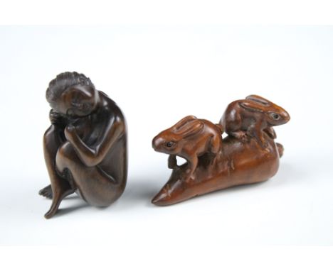 Two Japanese wooden carved netsuke of a nude female and a rabbits on a carrot, both with character marks to base.