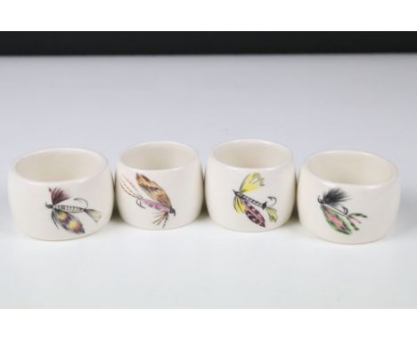 A set of four ceramic napkin rings hand painted with fishing flies. 