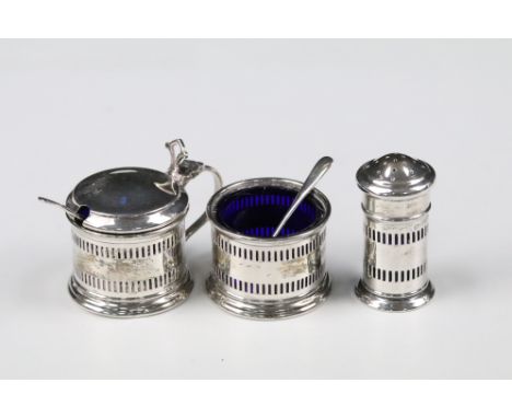 Early 20th century silver cruet set, comprising salt, pepper and mustard, all the blue glass liners together with two spoons,