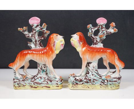 Late 19th century pair of hunting Staffordshire dogs with tree background, H 19cm (2)