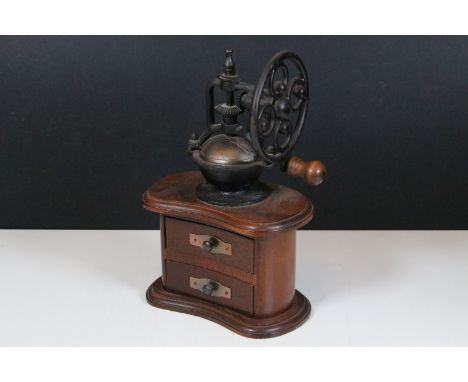 French style coffee grinder with metal mechanism on a mahogany kidney shaped base having two drawers, 30cm high