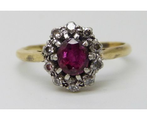 An 18ct gold and platinum set ruby and diamond cluster ring, 2.8g, M