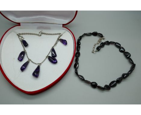 An amethyst drop necklace and an amethyst necklace with a silver clasp 