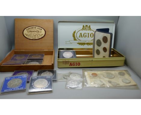 A 1965 Canadian proof coin set, a 1958 Canadian dollar, a US 1943 half dollar and 1965 quarter, one other Canadian coin, Brit