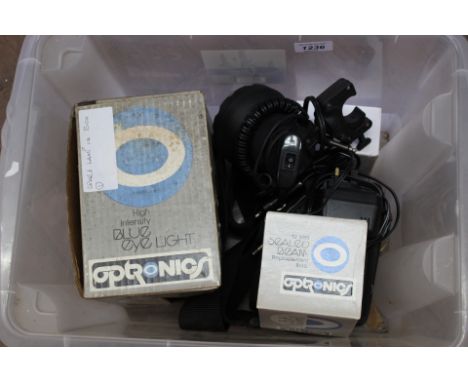 An Optronics 'blue eye light' with accessories including spare lamp with a 'Clulite' light and accessories