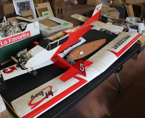 Two engine propelled monoplanes plus a wooden pond yacht