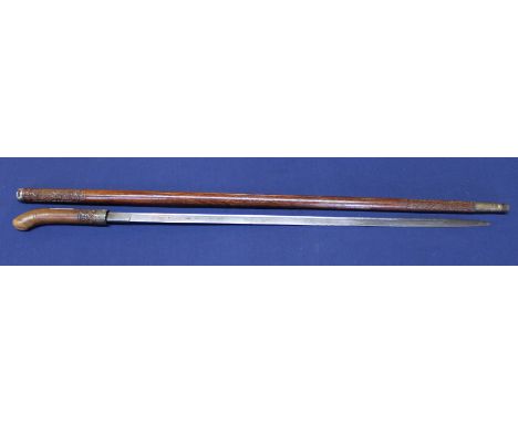 An Anglo Indian sword stick with carving to handle and scabbard